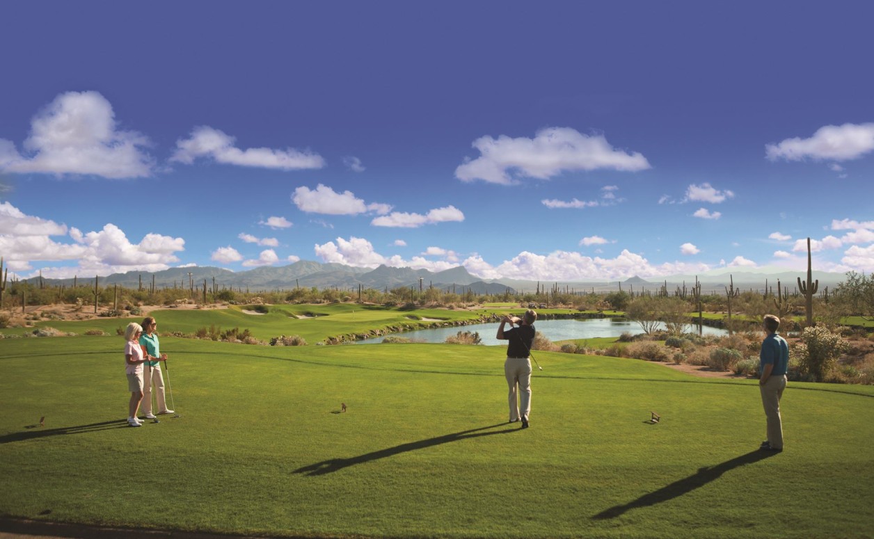 Two women and two men playing golf. The Ritz-Carlton Residences is a highly-customized, whole-ownership, private luxury Dove Mountain real estate community.