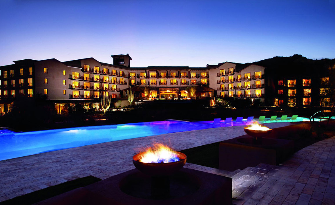 The Ritz-Carlton Resort in Dove Mountain, Marana, view of the hotel and pool at night, with the resort windows lit up.